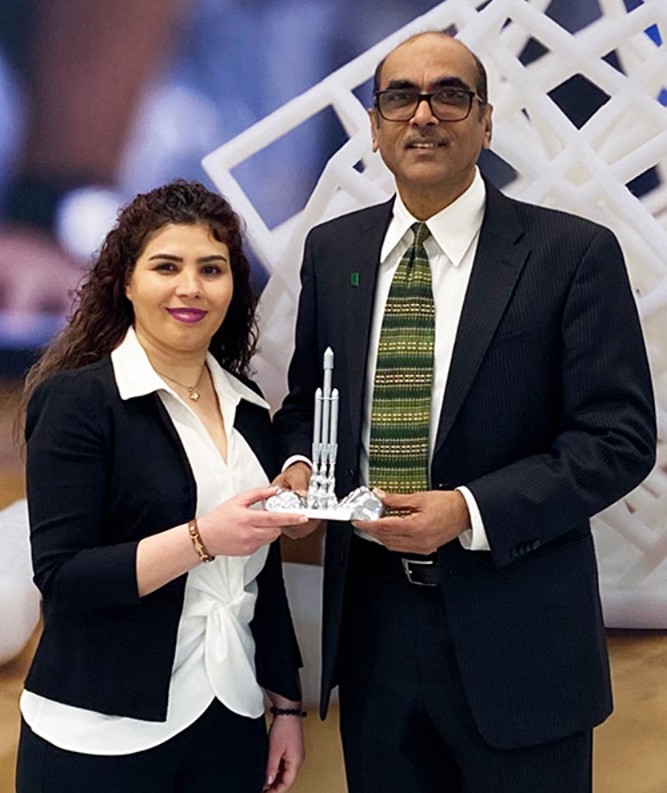 The professor Vijay Mannari and the Ph.D. student Neda Hayeri holding the Special University Award together