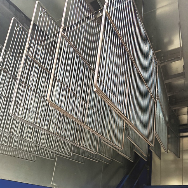 Components entering the bell-type curing oven.