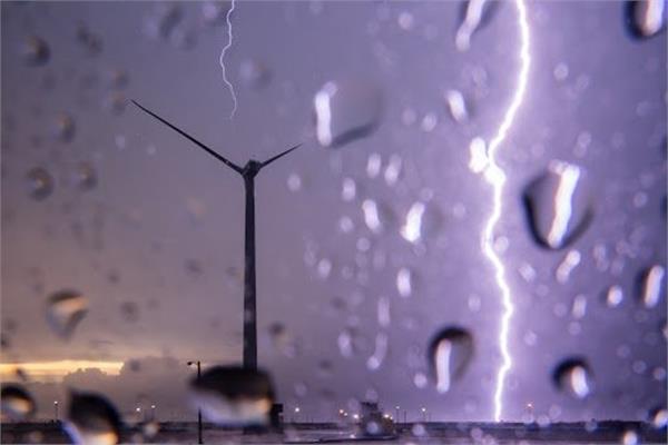 A wind turbine during a storm protected from lightning with the ArcGuide coating