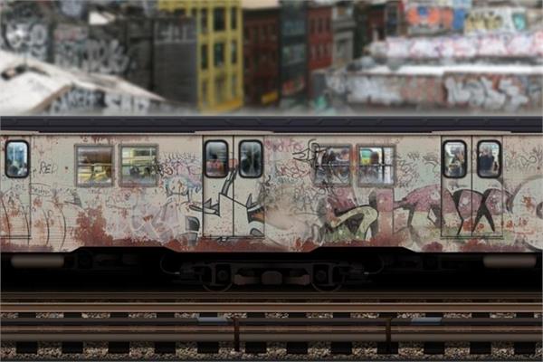 A grey-painted train with graffiti