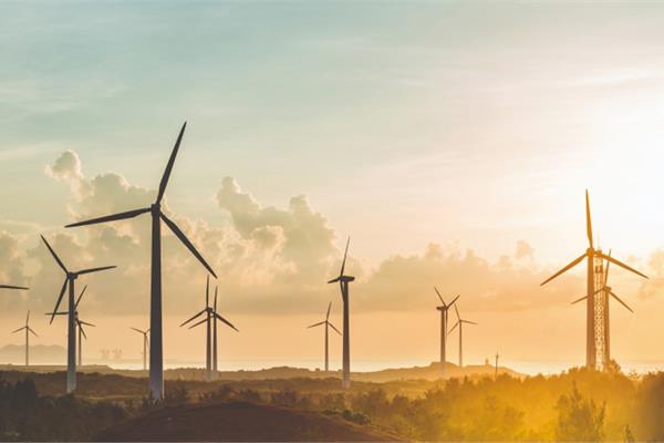 A wind power plant at sunrise