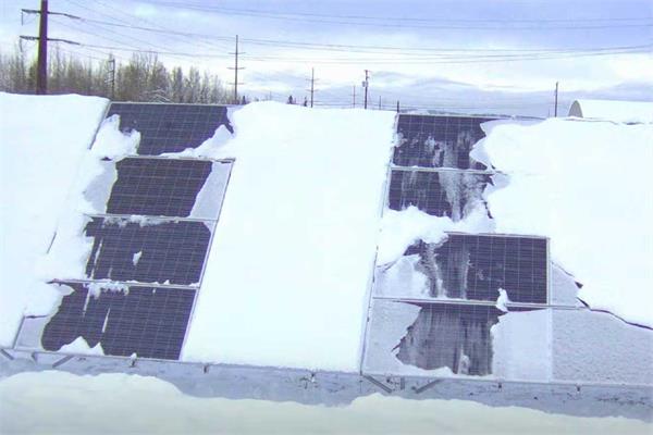 Solar panels partially covered by snow