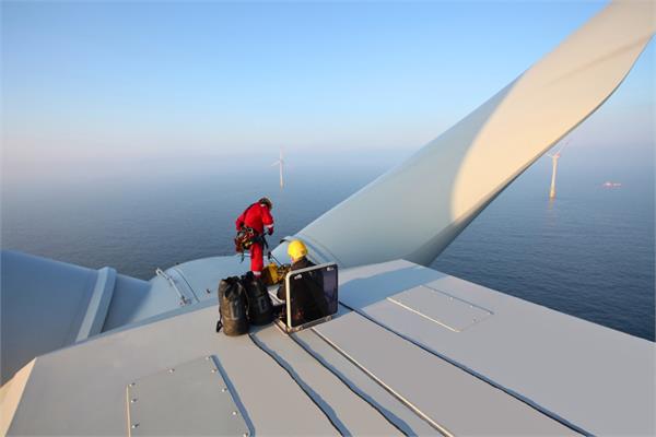 Photo of a coating applicator on a wind turbine