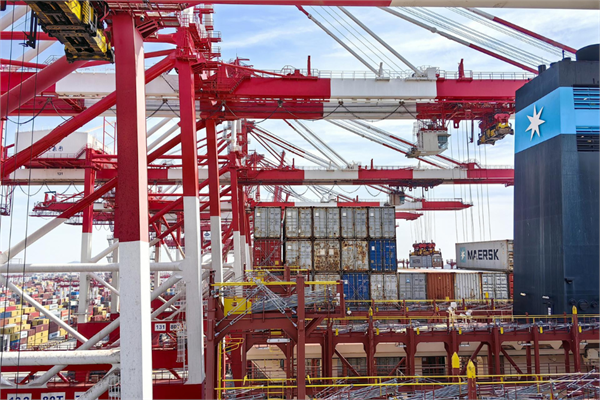 PHOTO: red and white port cranes.