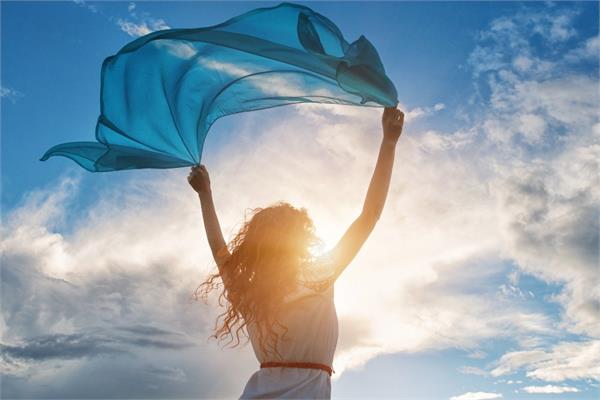 A woman enjoying the wind and the sun in a bright day